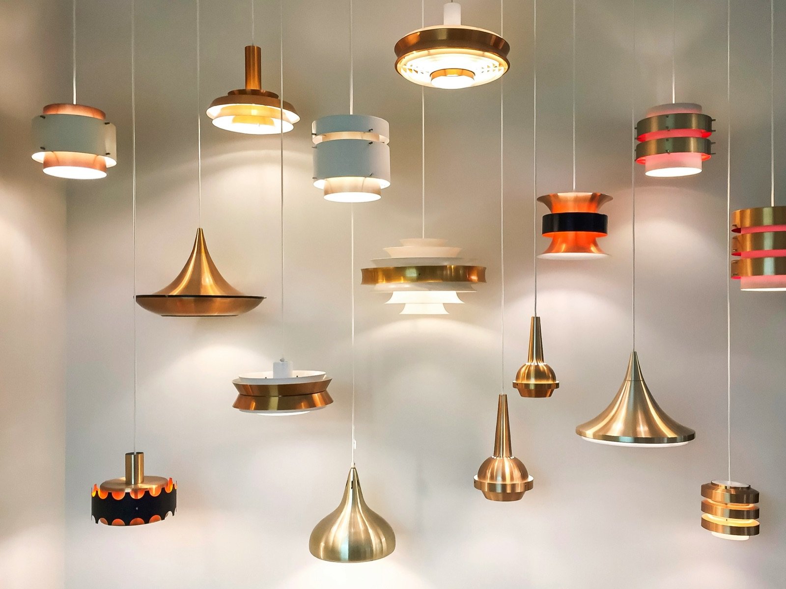 A colorful array of vintage pendant lights hanging together