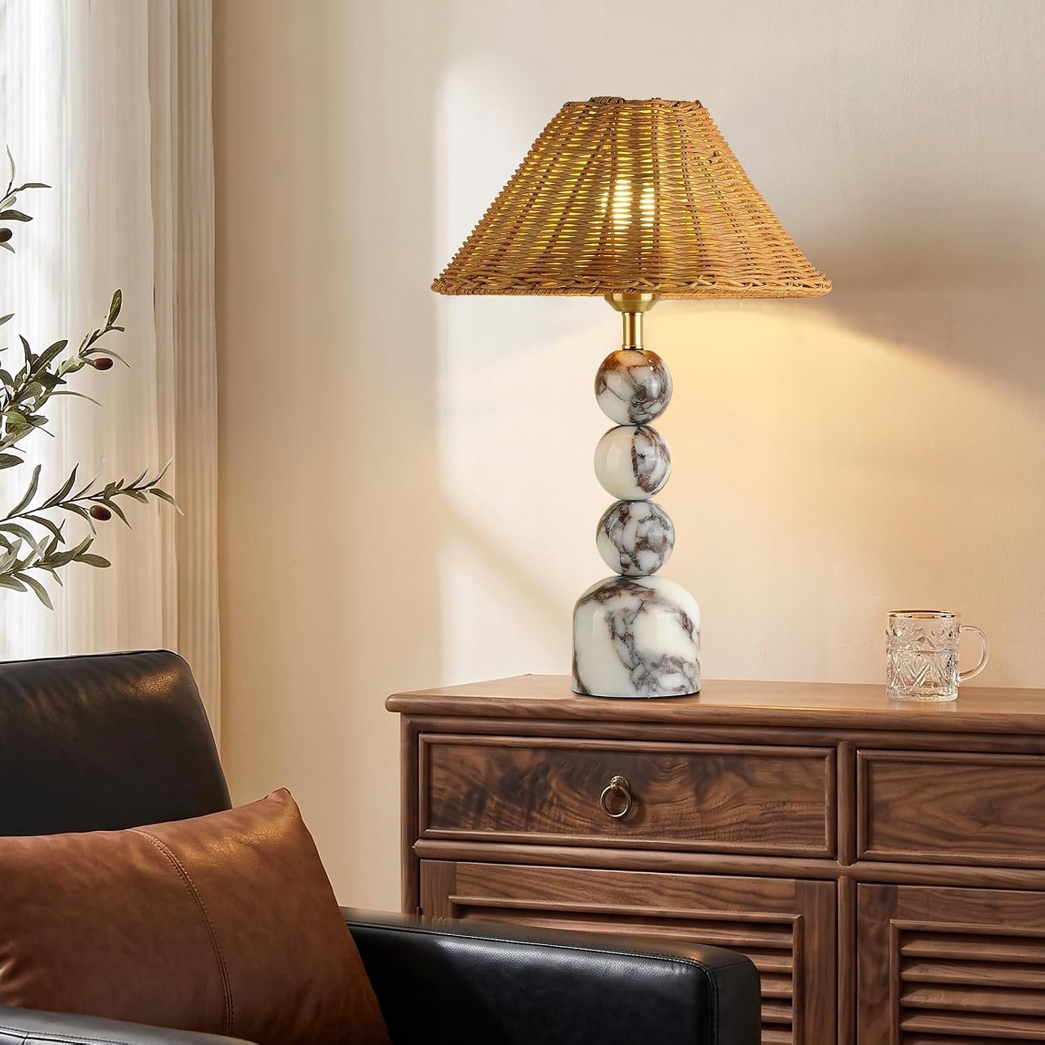 Unique marble table lamp with stacked Calacatta stone balls and a vintage rattan lampshade, styled on a wood dresser for aesthetic home decor